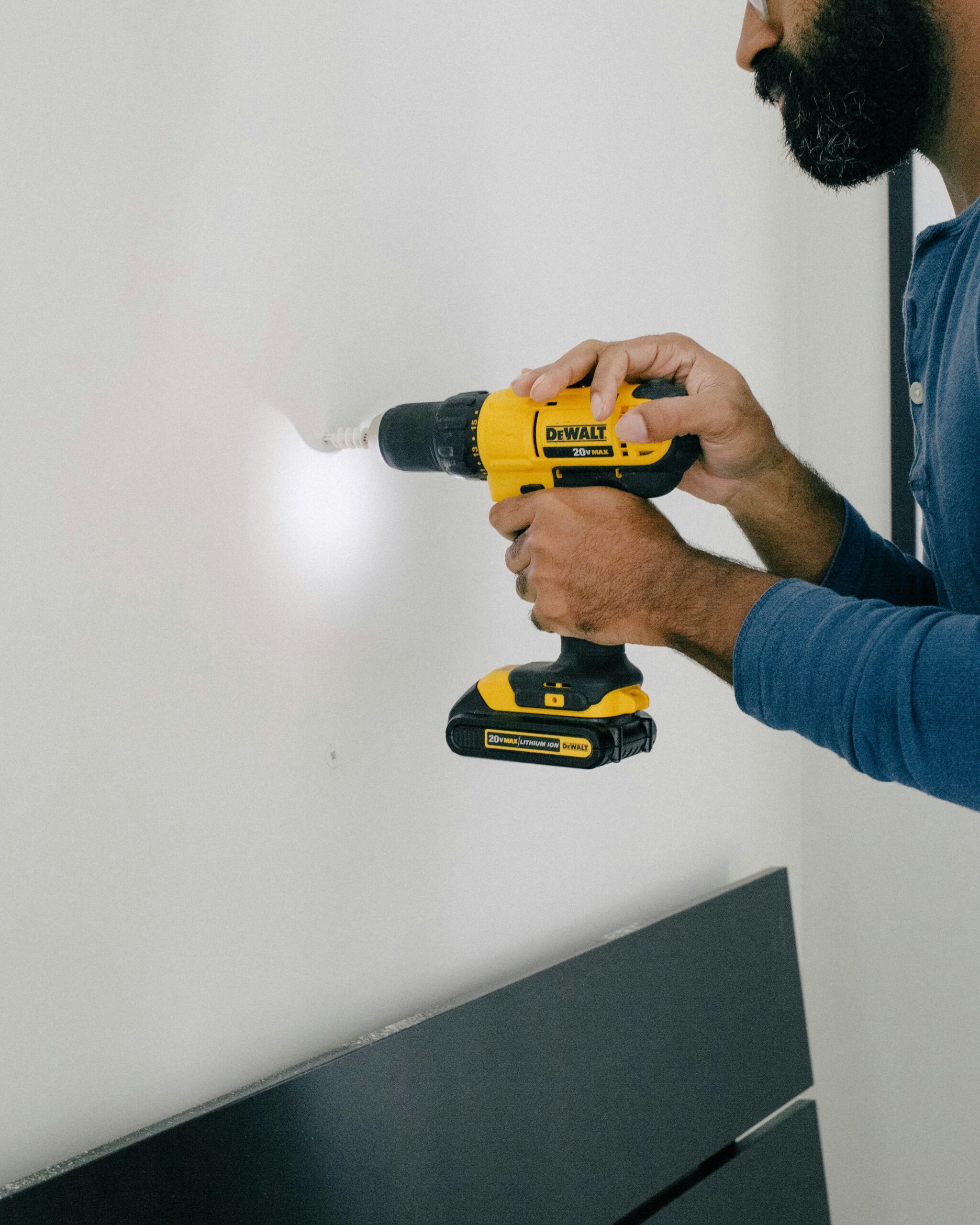 Man drilling into a wall representing a good quality contractor